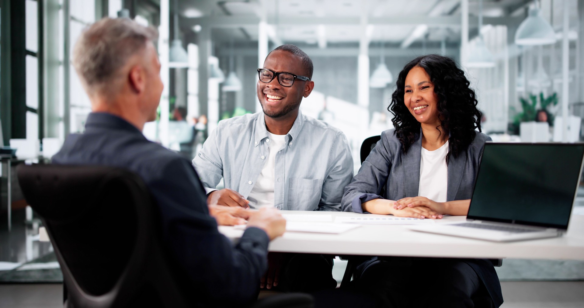 Excited Hispanic Couple Consult Trusted real estate agent